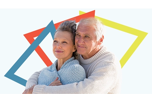 An older couple both looking confidently ahead while embracing each other.